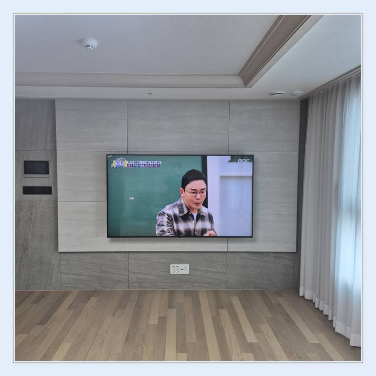 벽걸이TV 설치 사진 - 벽면에 걸린 TV와 창가 쪽 간격